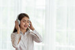 © surachetkhamsuk - Young Asian woman enjoy listening to music with headphones, happy and relaxing time