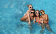© New Africa - Happy family in outdoor swimming pool on sunny summer day. Space for text