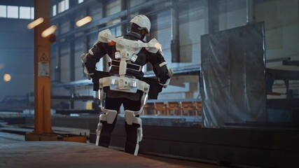 Fototapete - Black African American Engineer is Testing a Futuristic Bionic Exoskeleton and Picking Up Metal Objects in a Heavy Steel Industry Factory. Contractor is Heavy Lifting Steel Parts in a Powered Shell.
