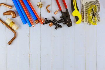 Wall Mural - Installation of plastic pipes for the water system, pipe cutting tools, corners, holders, taps, adapters and work gloves on equipment for plumbing