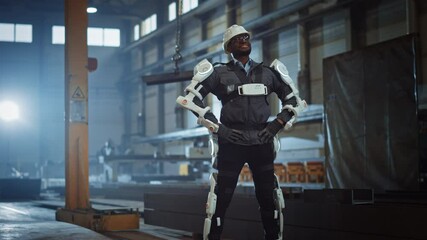 Poster - Black African American Engineer is Testing a Futuristic Bionic Exoskeleton and Proudly Wearing it in a Heavy Steel Industry Factory. Successful Contractor Posing in a Powered Mobile Machine Shell.
