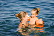 © amelie - Mother playing with daughter in sea