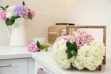 Canvas Print - Beautiful bouquet of hydrangea flowers on light countertop, closeup