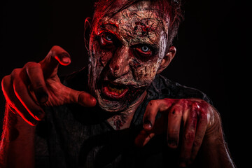Wall Mural - Scary zombie on dark background. Halloween monster