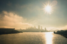 A Foggy, Misty Morning Over The Pittsburgh Ohio River With Bridges And Urban Buildings And Infrastructure.