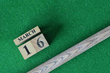 March 16, Number cube With a snooker stick on a green background, snooker table.	
