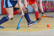 © skumer - Young woman player in attack at indoor hockey match