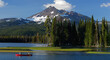Panorama of canoers on Sparks Lake under Broken Top in Oregon