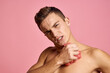 © SHOTPRIME STUDIO - Nude man with a washcloth in his hand on a pink background cropped view