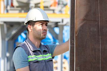 Construction worker is checking to steel material in the construction site.