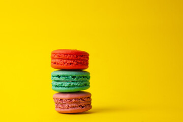 French colorful macarons on a yellow background.Dessert, sweets.