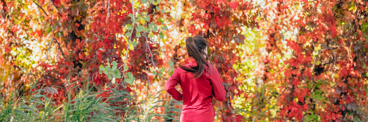 Wall Mural - Autumn outside jogging woman runner running on red leaves background panorama. Banner header crop.