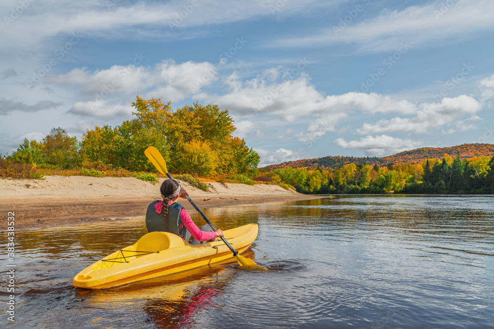 Kayak fun water sports down on river in Laurentians, Quebec. Canada travel destination. Woman kayaker kayaking in Mont-Tremblant during autumn. - obrazy, fototapety, plakaty 