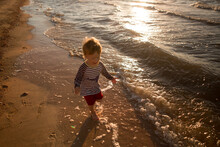 Children Run Along The Shore Of The Sea Of Azov