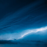 Fototapeta Tęcza - Bright Lightning On Blue Night Sky During Hunderstorm