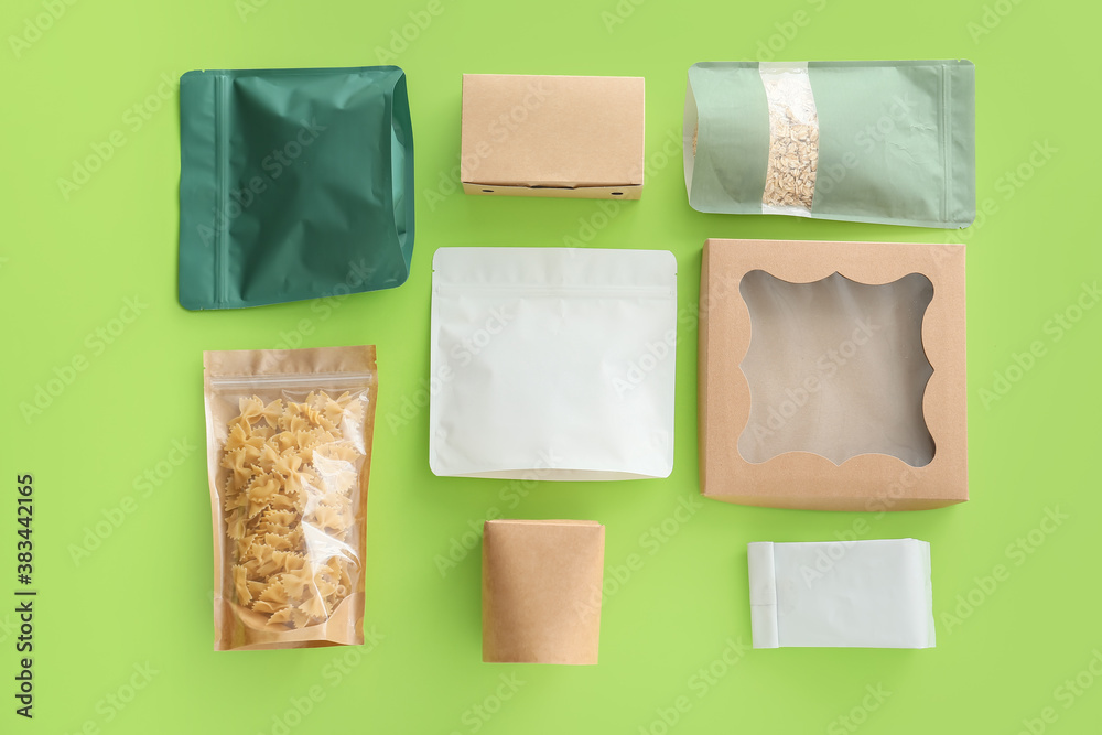 Packages for food on color background