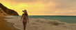 © Njay - A girl walking on near the sea and looks at the sunset.
