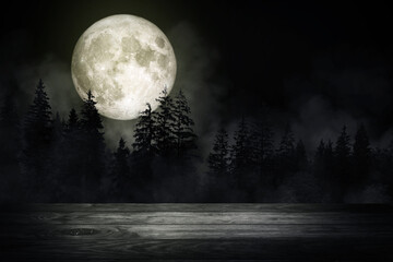wooden table top with forest in the dark night and fog or mist with full moon in background. (elemen