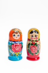 Wall Mural - Russian doll. Two wooden dolls of different colors on a white background