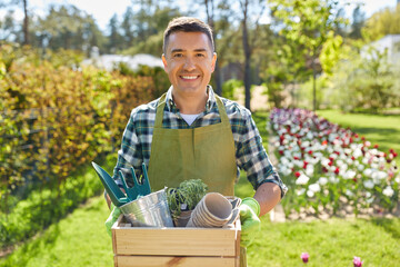 Sticker - gardening and people concept - happy smiling middle-aged man in apron with tools in box at summer garden