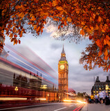 Fototapeta Londyn - Night traffic jam with autumn leaves against Big Ben in London, England, UK