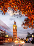 Fototapeta Big Ben - Night traffic jam with autumn leaves against Big Ben in London, England, UK
