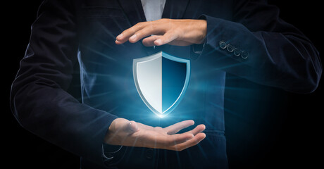 Fototapete - Closeup of businessman holding security shield hologram