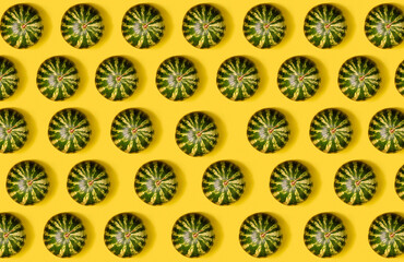 Food pattern. Repeating silhouette of round green fresh watermelon on yellow background. Many round watermelons in even rows on a yellow background. Horizontal.