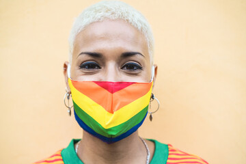 Wall Mural - Young lesbian woman with rainbow flag gay pride mask - Lgbt rights concept