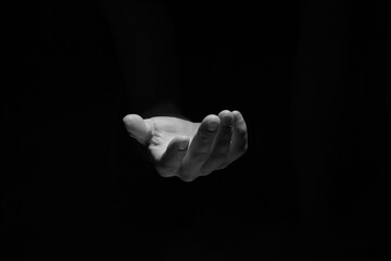 Support hand on a dark background. Helping hand from the dark