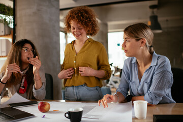 Poster - Businesswomen working on a new project. Colleagues discussing about problem they have to solved..