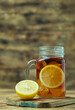 © Poramet - Iced tea with lemon slices and mint on wood background