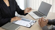 © Puwasit Inyavileart - HR head is interviewing a young man's job application in a private room.