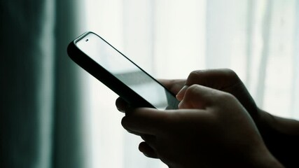 Poster - Man using smartphone in the living room at home, Close-up of hand typing message