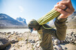 © Cavan Images - Climber prepares rope for another day of climbing on Baffin Island.