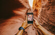 © Cavan Images - Taking picture with phone of narrow slot canyons in Escalante, Utah
