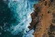 © Cavan Images - Aerial top view of sea waves hitting rocks on the beach with turquoise
