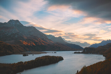 Wall Mural - Aerial view on autumn lake Sils (Silsersee) in Swiss Alps mountains. Colorful forest with orange larch. Switzerland, Maloja region, Upper Engadine. Landscape photography