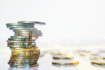 Double exposure of city background and rows of coins. business financial for investment and banking concept.