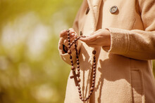 Close Up Young Girl Holding Rosary And Praying To God