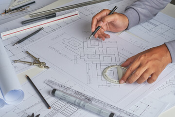 Architect engineer contractor design working drawing sketch plan blueprint and making architectural construction house building in architect studio.