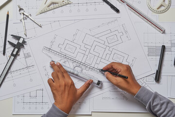 Architect engineer contractor design working drawing sketch plan blueprint and making architectural construction house building in architect studio.