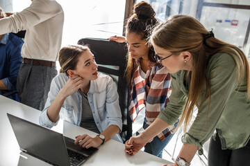 Group of female designers and programmers starting a new project at the office.	
