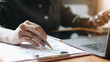 © wichayada - Business man investment consultant analyzing company annual financial report balance sheet statement working with documents graphs. Concept picture of business, market, office, tax.