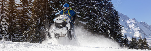a Pro snowmobiler makes a jump with a big blast of snow and epic falls. Boondocker sports snowmobile