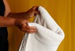 Woman folding a white blanket. Cozy, warm blanket. Laundry concept. Home textile. 