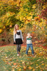 Sticker - Happy little kids with autumn leaves in the park