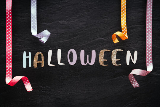 The word halloween on minimal pastel greeting card , frame, banner.