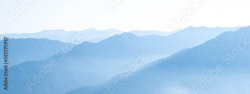 Cuadros en Lienzo Mountain range banner. Rocky mountains in morning haze