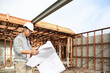 © Amelia Soegijono/Austockphoto - Builder checking construction plans on-site